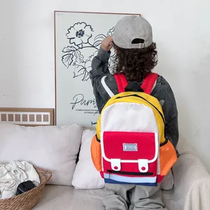 Lightweight color-block backpack for kids featuring vibrant red and yellow pockets