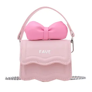 Pink mini crossbody bag with a large bow detail and wavy flap for kids and women