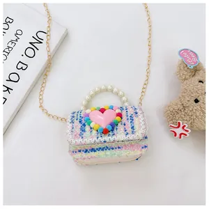 Dettaglio borsa tweed bimbi con cuore rosa manico di perle e finiture in pizzo