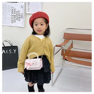 Pink plaid children's tweed crossbody bag featuring pearl handle and cute bow detail