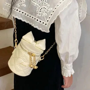 White quilted cylinder bucket bag for girls with bow decor and heart embroidery