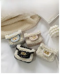 Detail of tweed mini bags with pearl trim and gold clasp in four assorted colors