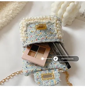Detail showing internal capacity of the blue tweed chain bag with cosmetics inside