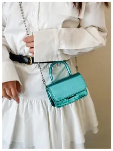 Mini metallic green crocodile pattern crossbody bag shown with silver bead chain strap