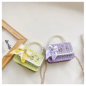 Close-up of tweed plaid handbags with bow detail, lace trim and pearl handle