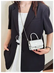 Silver mini crossbody bag with crocodile texture and metallic bead chain strap detail