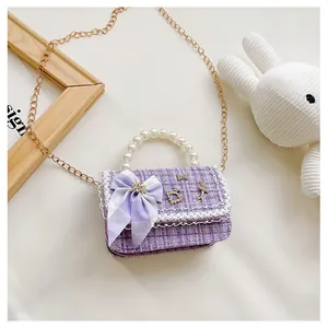 Detailed macro view of purple tweed fabric with lace trim and elegant pearl handle