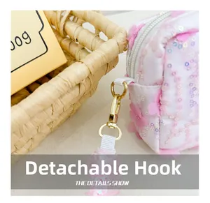 Macro detail of detachable gold spring hook and sequined fabric on the pink floral bag