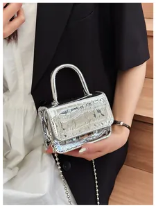 Close-up of silver mini PU bag with crocodile texture and metal ball chain strap
