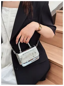 Detailed macro view of the silver crocodile pattern texture on a mini handbag