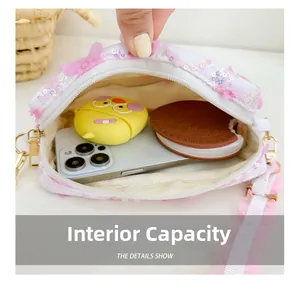 Internal capacity of kids sequin crossbody bag showing phone and earphone storage