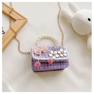Detail of purple plaid tweed bag with pearl handle and mesh bow for little girls