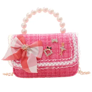 Pink tweed kids handbag with pearl handle, red plaid bow, and golden chain strap