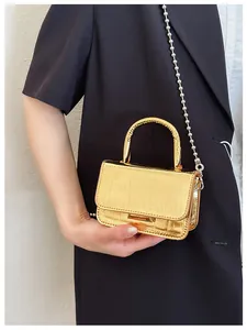 Detailed close-up of golden crocodile texture PU crossbody bag with elegant bead chain strap