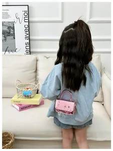 Pink metallic crocodile texture micro bag shown on a young girl for size perspective