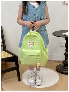 Close-up of lime green nylon backpack with biscuit charm and fashion trends embroidery