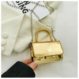 Detailed close-up of golden PU leather mini bag with embossed crocodile texture and silver chain