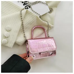 Detail of metallic pink mini bag with crocodile texture and silver ball chain strap