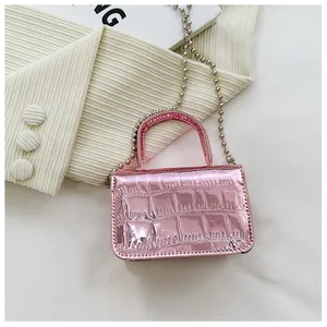 Detail of pink metallic mini handbag with crocodile texture and silver bead chain strap