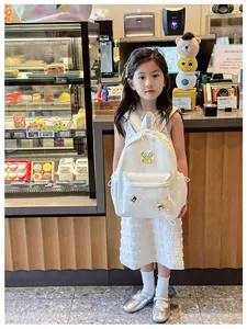 Close-up of white nylon children backpack with rabbit embroidery and R BEST patch detail