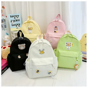 Collection of nylon kids backpacks with cartoon animal patches in five vibrant colors