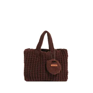 Deep brown chunky knit tote bag with handmade leather label and waffle texture