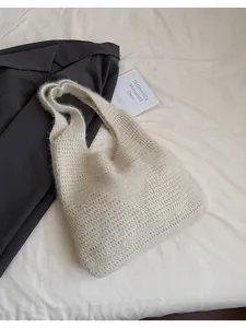 Detailed texture of off-white knitted tote bag with soft mohair-like fuzzy surface