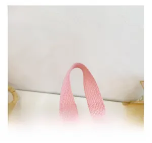 Close-up of the reinforced fabric handle on the pink nylon cartoon backpack for kids