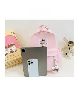 Pink nylon kids backpack size comparison showing internal capacity for tablets