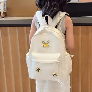 Kids nylon backpack with cartoon rabbit patch and star pendant in creamy white