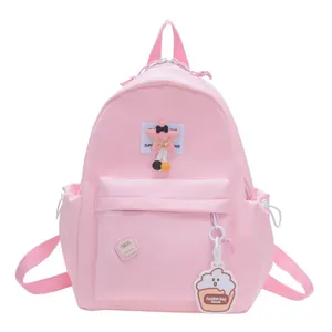 Pink nylon kids backpack with star plush pendant and multiple storage pockets
