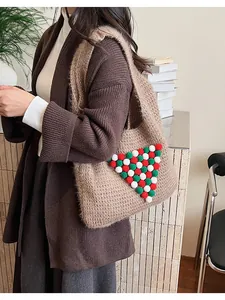 Detail of khaki knit tote bag featuring a decorative pom-pom Christmas tree design