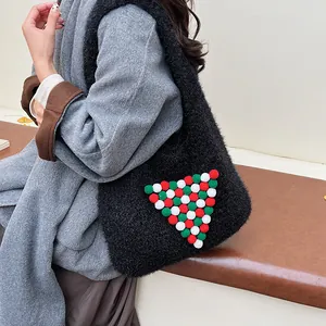 Fuzzy black tote bag with festive pom-pom Christmas tree design on shoulder