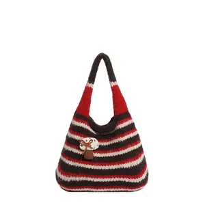 Borsa hobo in maglia con strisce retrò e simpatica applicazione a fungo su fondo bianco