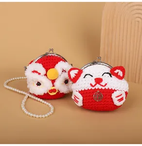 Close-up of handmade knit lucky cat and lion dance bags with pearl strap and metal clasp