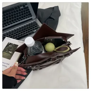 Macro view of wide star-shaped leather bag interior showing high storage capacity