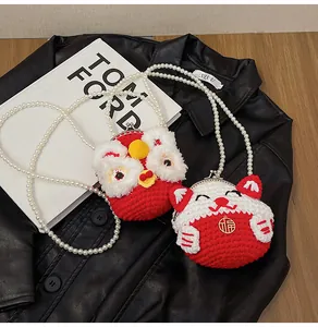 Detail of beaded mini bags showing lion dance and lucky cat designs with pearl straps
