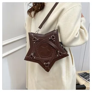 Detail of star-shaped crossbody bag in dark brown PU leather with silver rivets and studs
