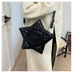 Star-shaped black crossbody bag with metallic silver hooks shown on a white wool coat
