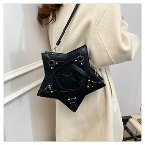 Detail of black star-shaped crossbody bag with silver rivets and leather lacing on coat