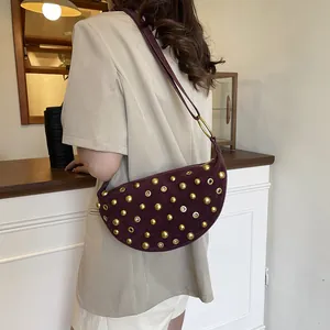 Vintage crescent shoulder bag in purple suede with rivet detailing and metal ring accents