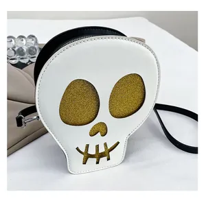 Detail view of skull crossbody bag with gold glitter eyes and white leather texture