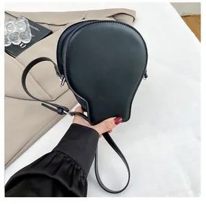 Detailed view of black bulb-shaped gothic crossbody bag with matte texture and adjustable strap
