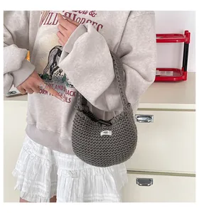 Dettaglio della borsa tote grigia a maglia con trama in cotone e logo egg cucito