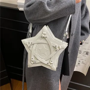 Minimalist white star-shaped crossbody bag with rivet straps shown on a model