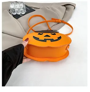 Detail of pumpkin crossbody bag with orange leather material and festive smile face design