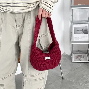 Borsa tote in maglia rosso scuro con etichetta 'egg.' in un contesto lifestyle