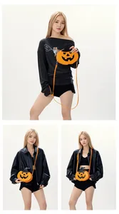 Detail of Halloween pumpkin crossbody bag with wizard hat design and orange strap