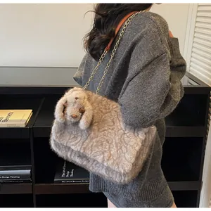 Detail of plush faux fur shoulder bag with chain strap and cute rabbit ornament
