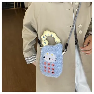 Detail view of blue plush cat crossbody bag with pink buttons and yellow handle